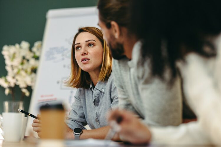 Young businesswoman having a discussion with her colleagues in a meeting